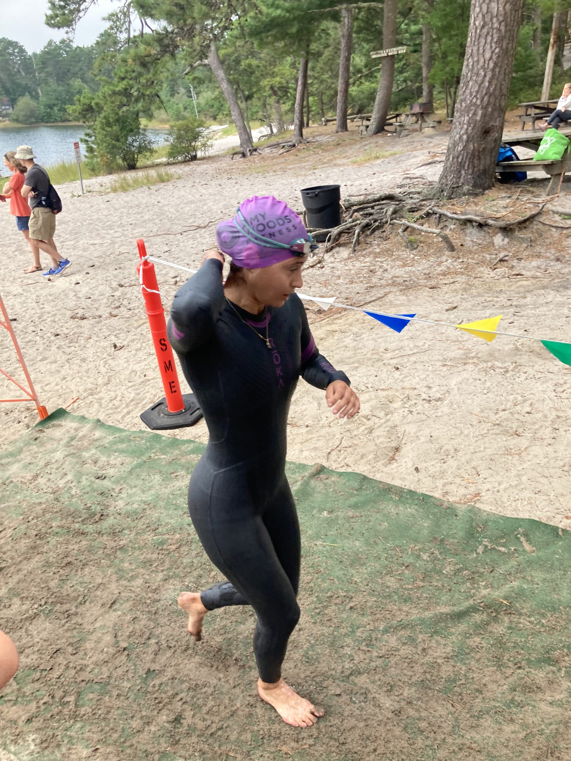 Triathlete unzipping swimsuit during transition.